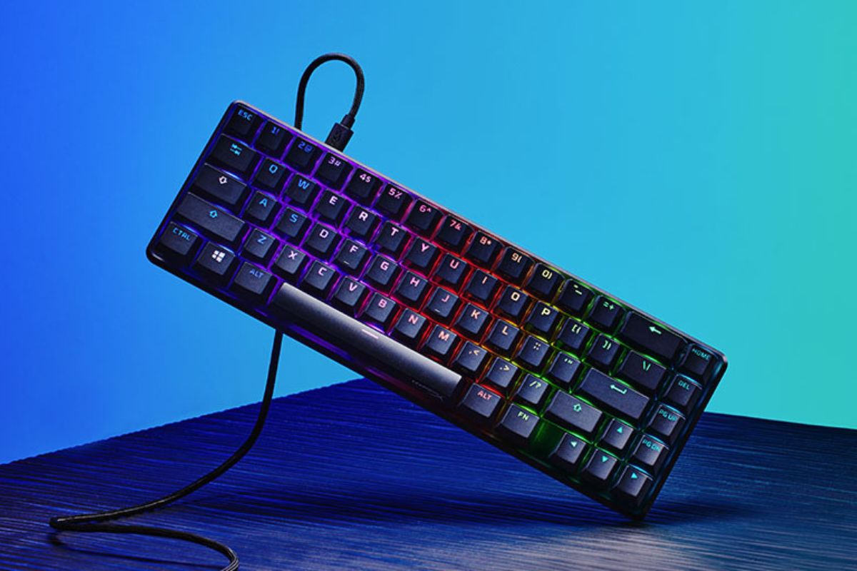Alloy Origins 65% gaming keyboard tilted on a blue gradient background