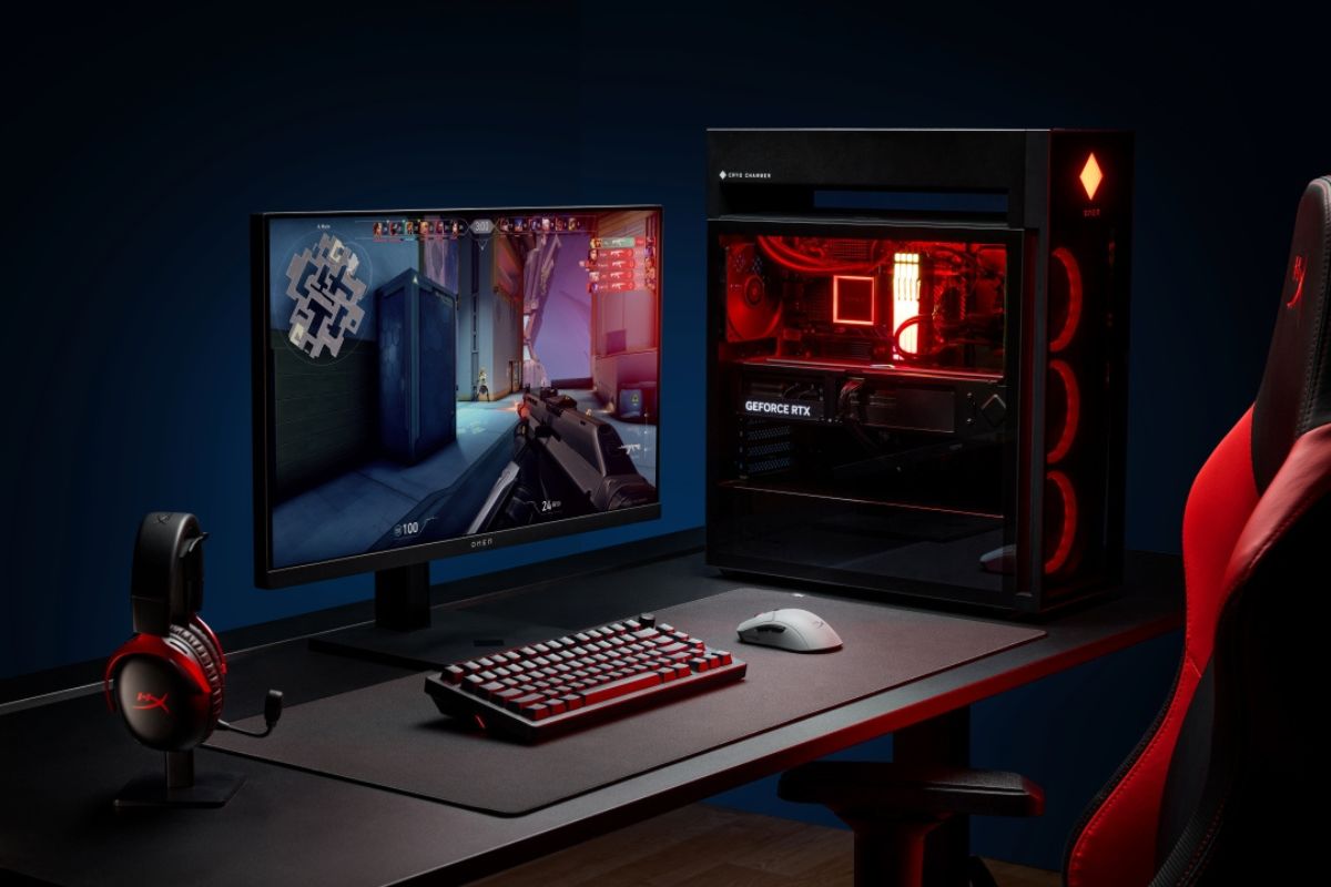 Alloy Rise 75 Wireless on a desk with a full gaming setup including PC, monitor, and headset